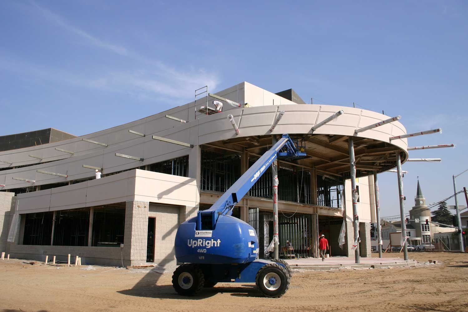 A crane in front of a half-constructed building on the UCSF Fresno campus