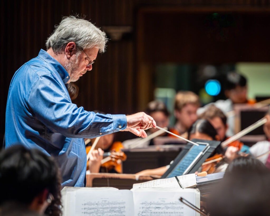 A conductor directs an orchestra