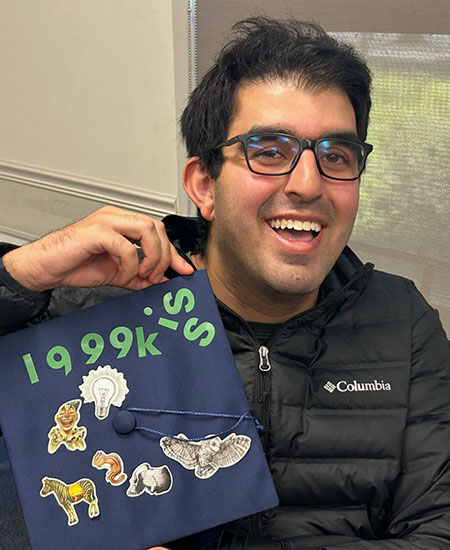 A student with a hand-decorated mortarboard