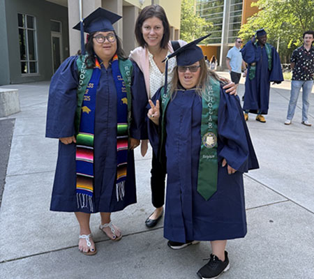 Students at graduation in robes, caps, and sashes