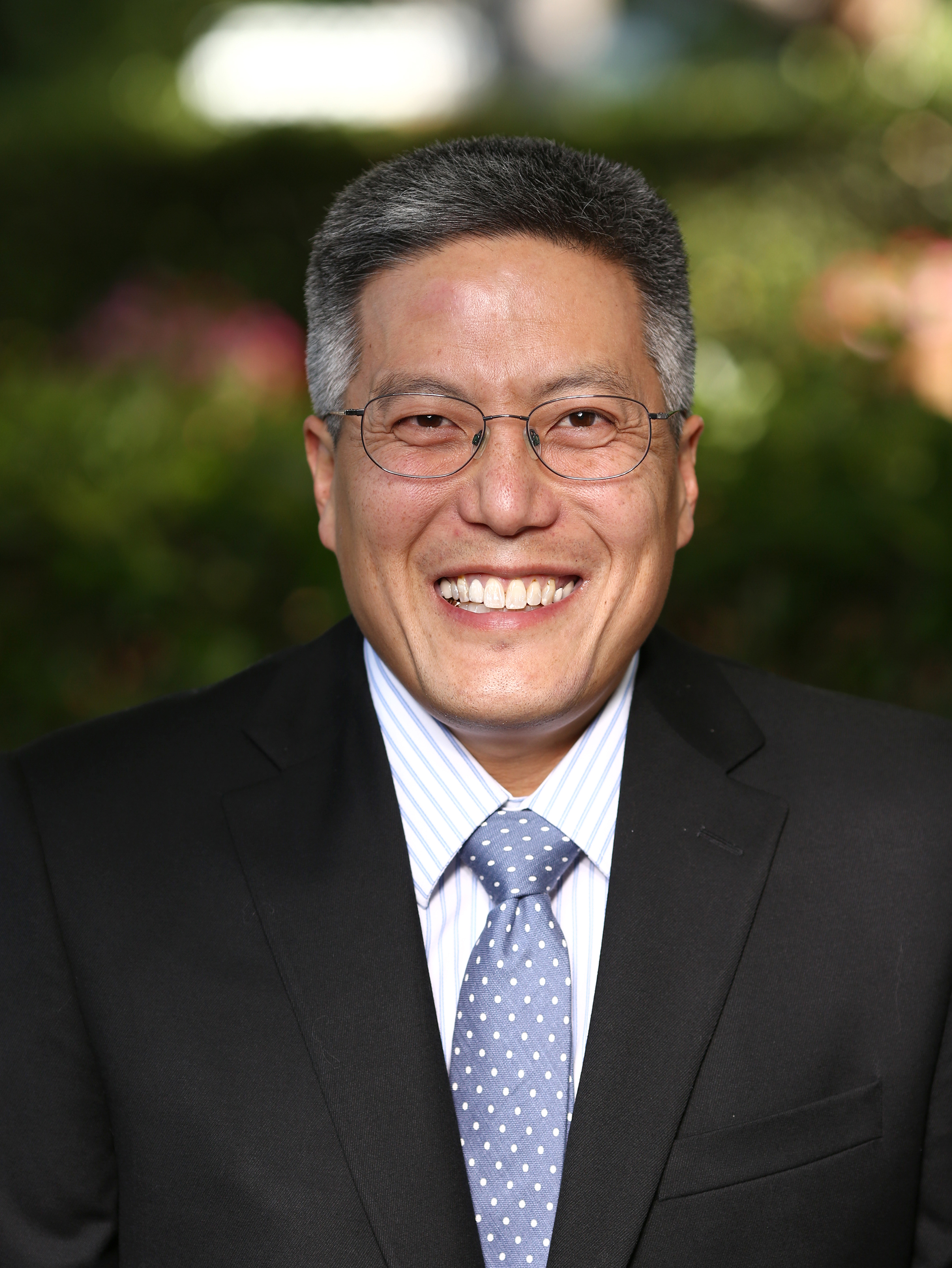 Man in suit smiles at camera