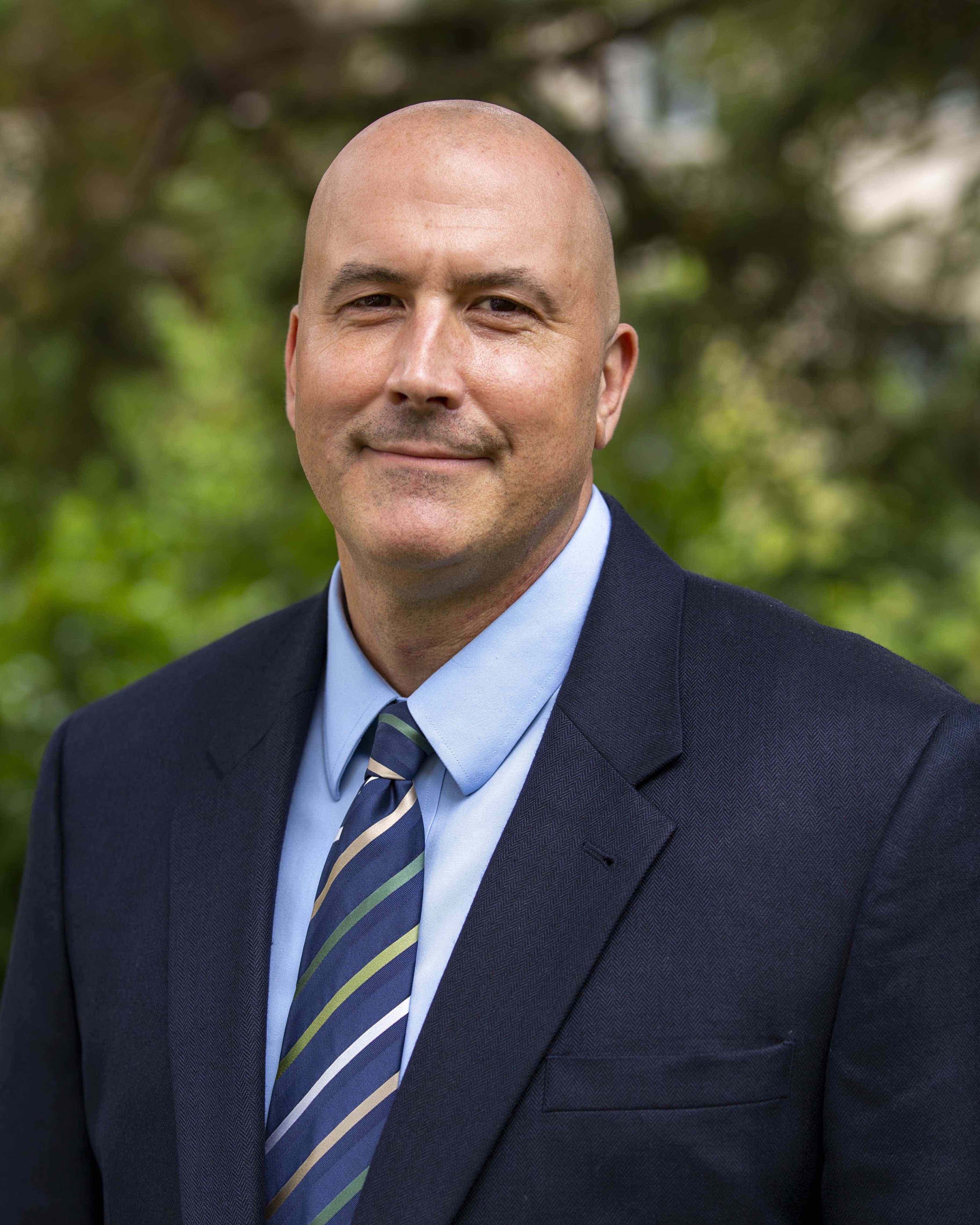 Man in blue suit jacket and blue tie