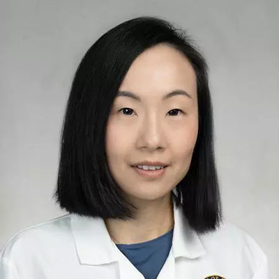 Y. Linda Liou smiles for a headshot wearing a white physicians coat
