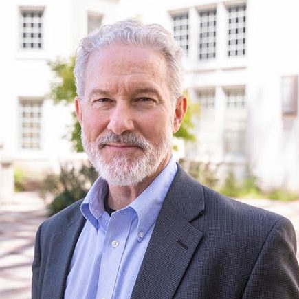Rich Lyons smiles for a headshot in an outdoor courtyard