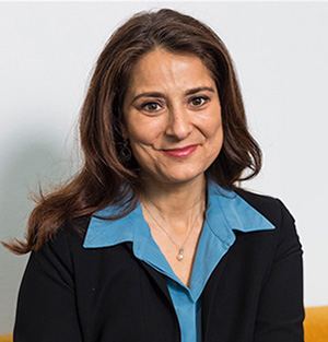 Professor Natalie Batalha smiles at the camera wearing a blazer and blue blouse
