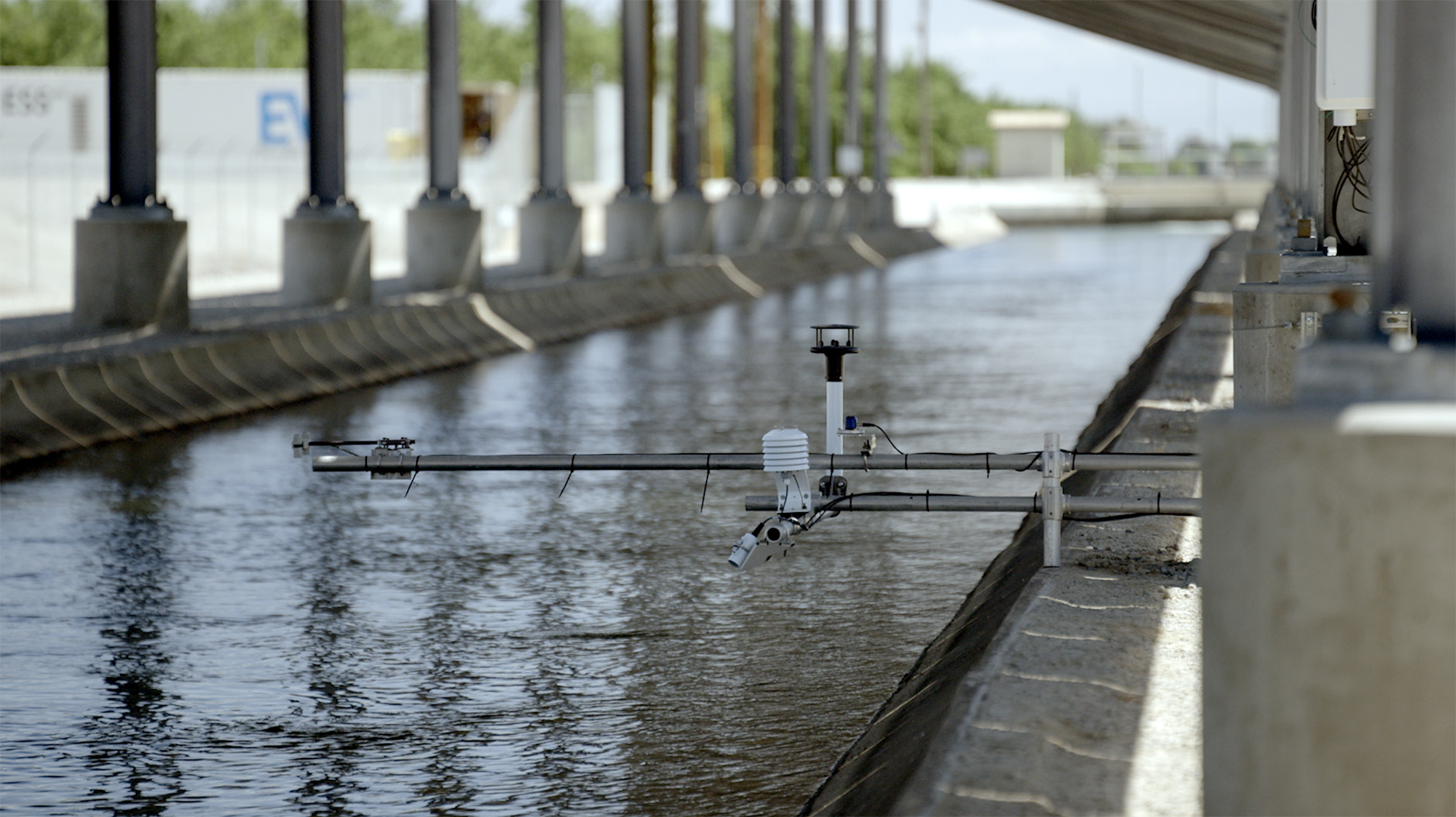 Sensors over the water in a canal that's covered with solar panels