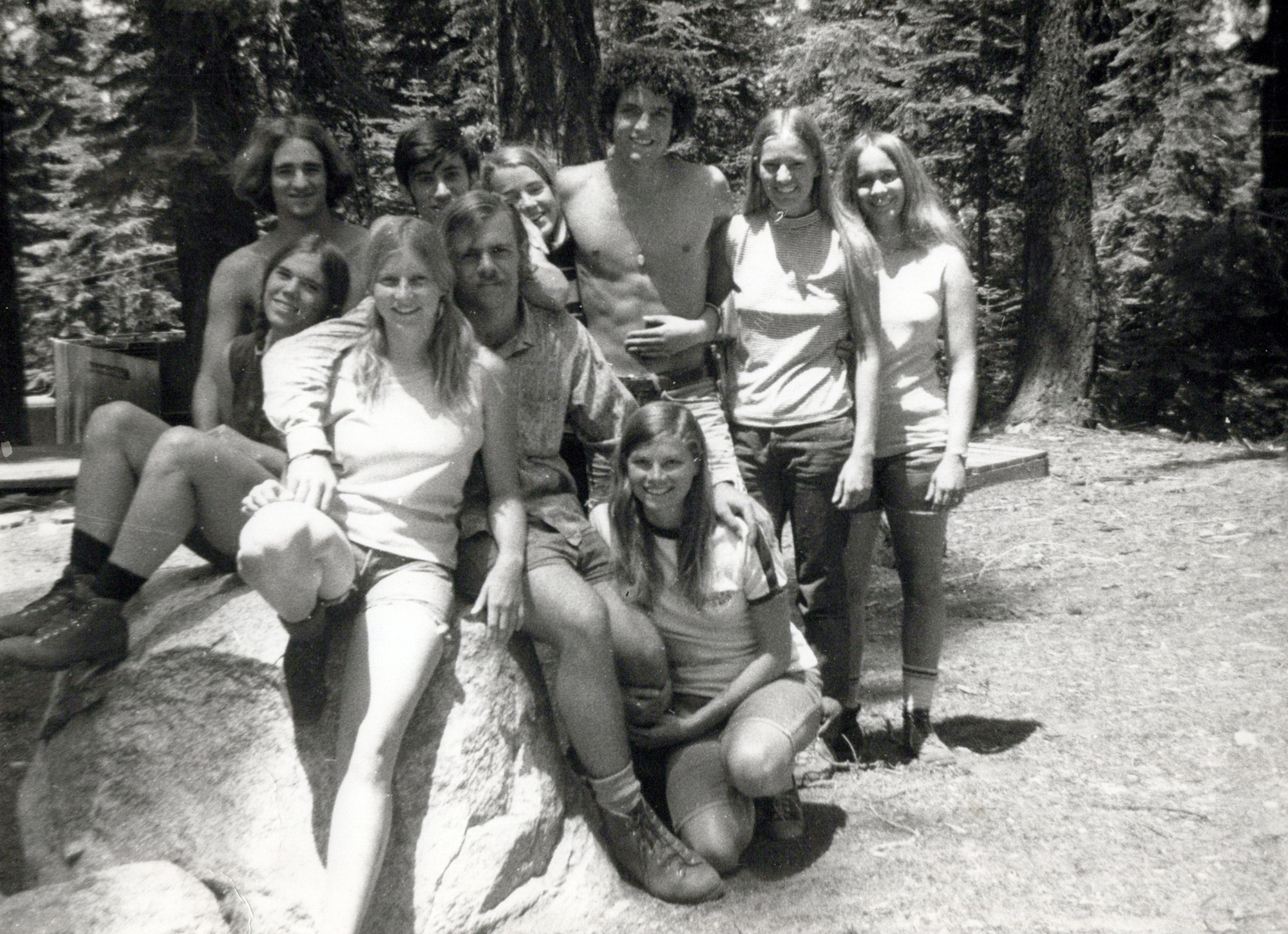 A black-and-white photo of a group of UC students in the woods