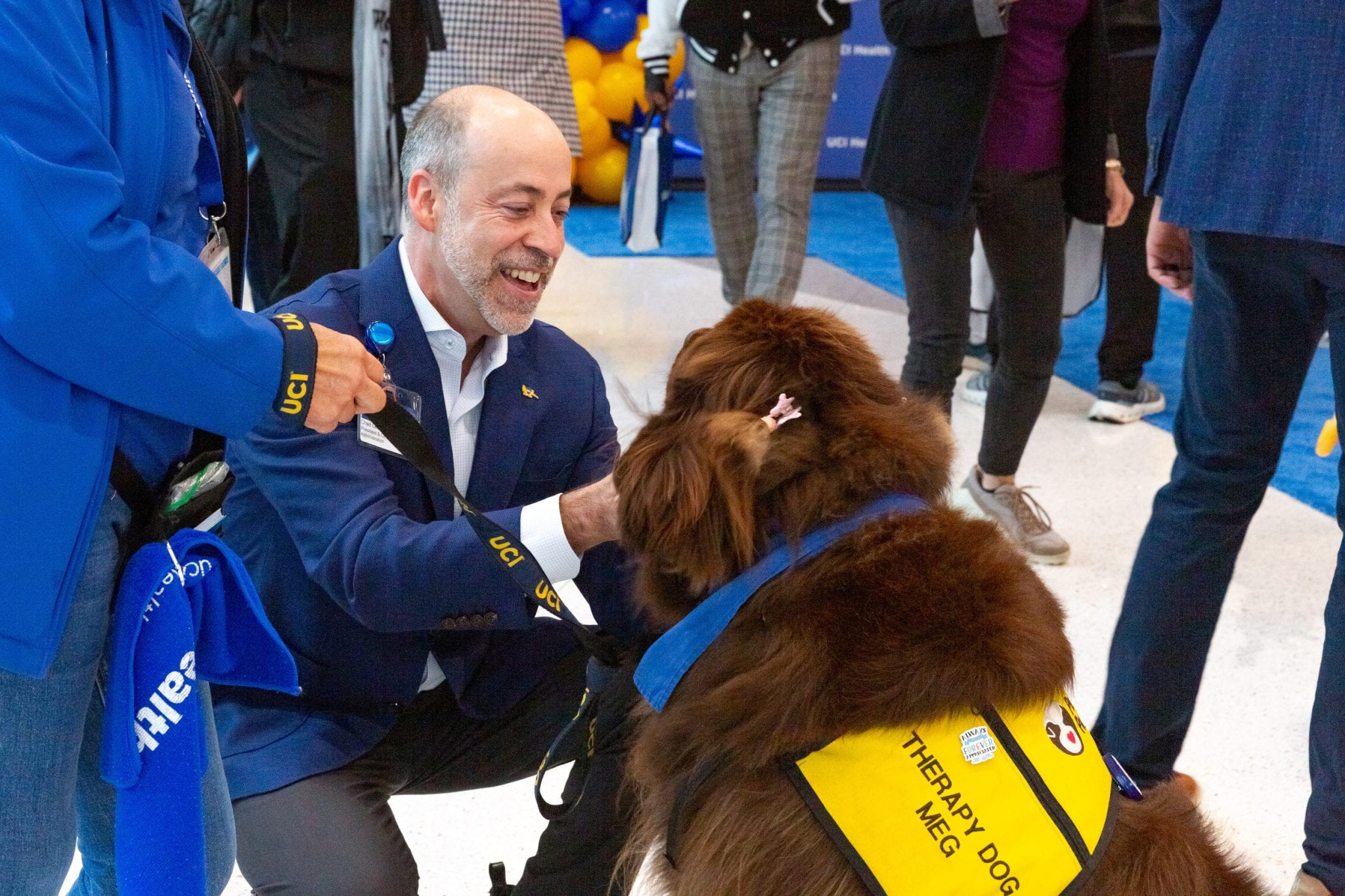 A man petting a therapy dog