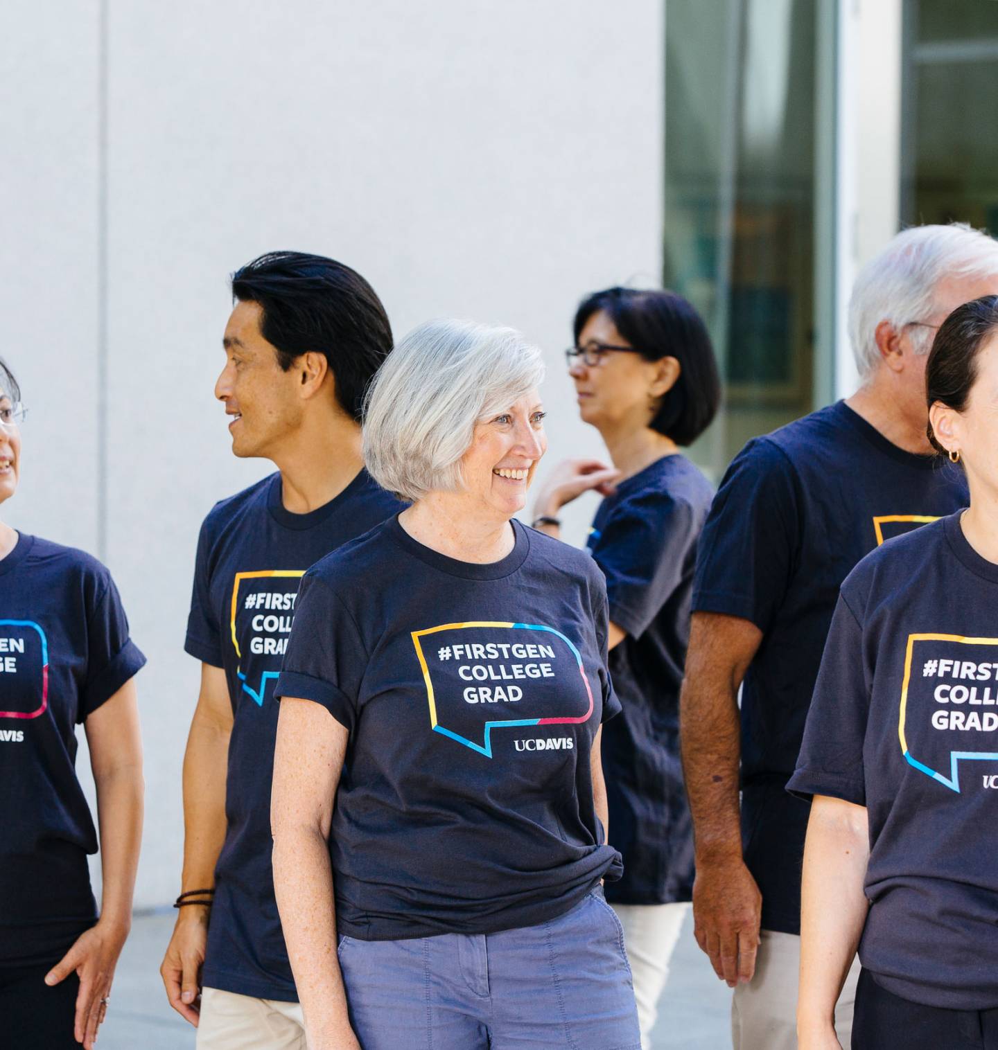 Group of faculty members with t-shirts on that say "First Gen"