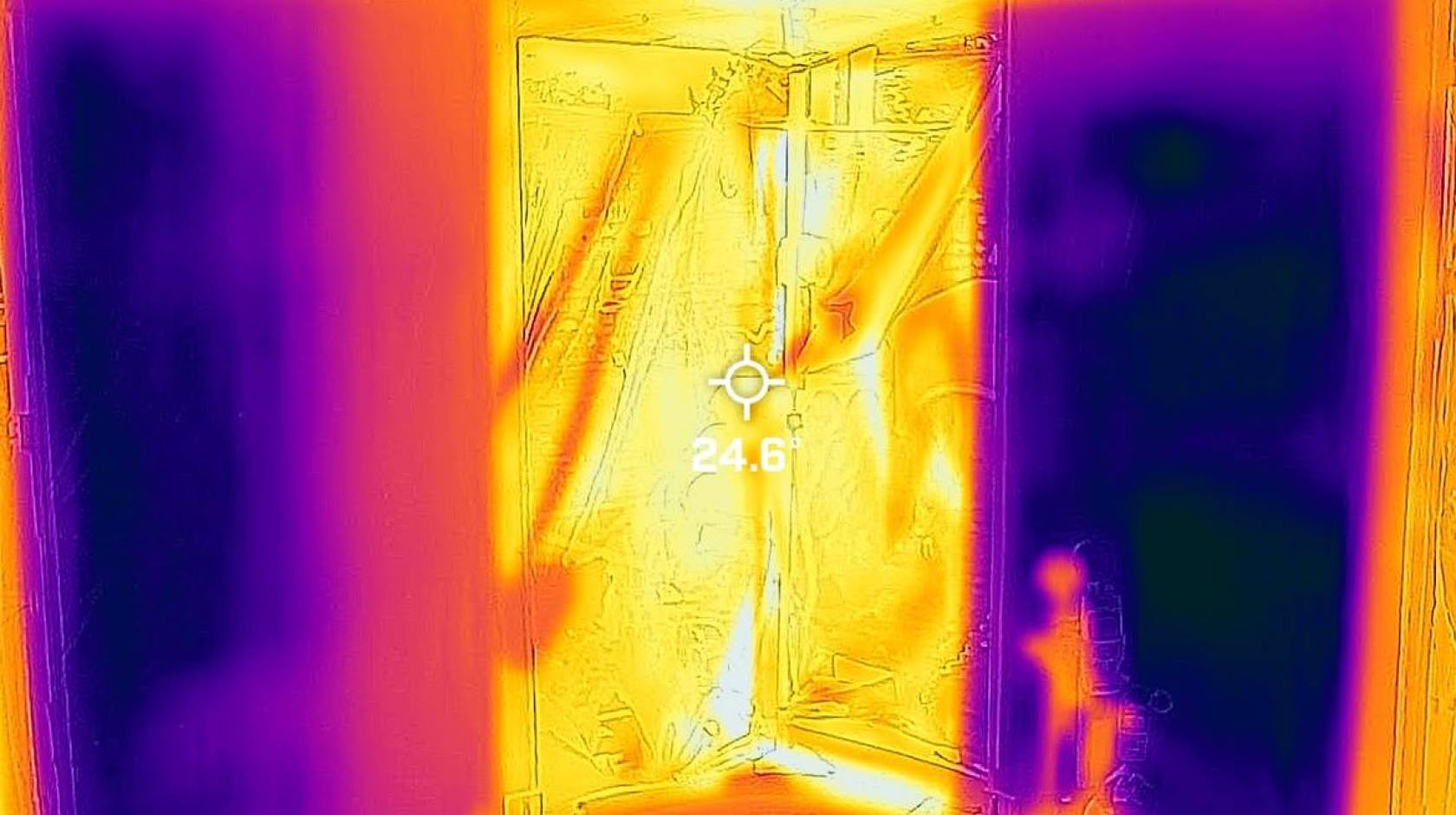 A thermal image with patches of bright yellow, orange, and purple