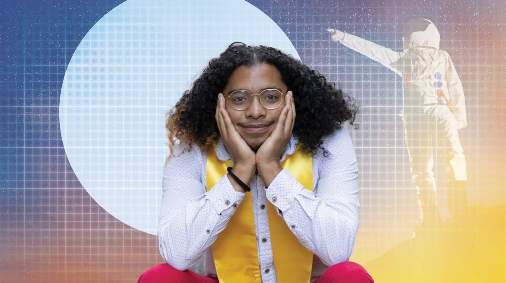 A young man with shoulder-length hair on his shoulders, wearing a stole, smiles at the camera propping up his chin, with the background bearing a gradient illustration of an astronaut pointing at the moon