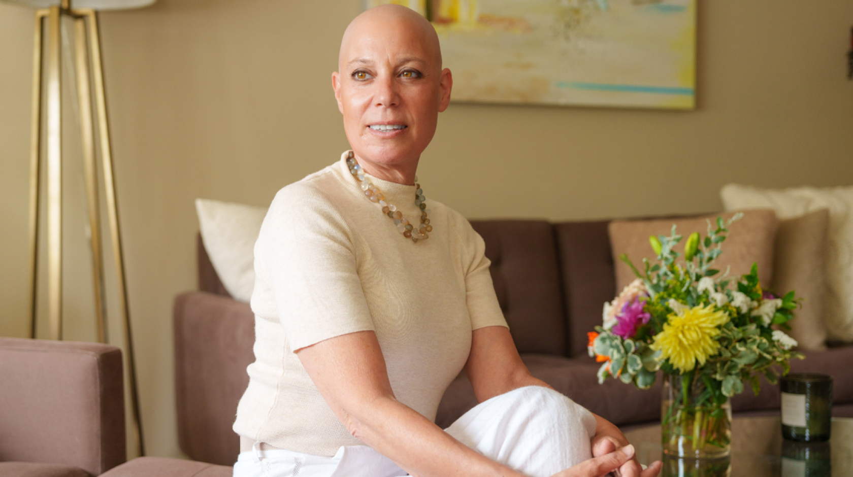 Well-dressed woman without hair on her head from chemotherapy looks into the distance