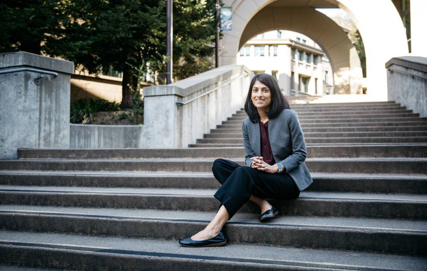 A professor sits on stairs on the UC Berkeley campus