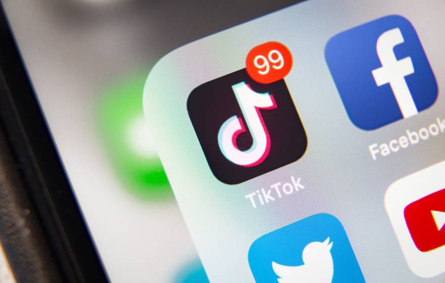 TikTok and other social media icons on a phone