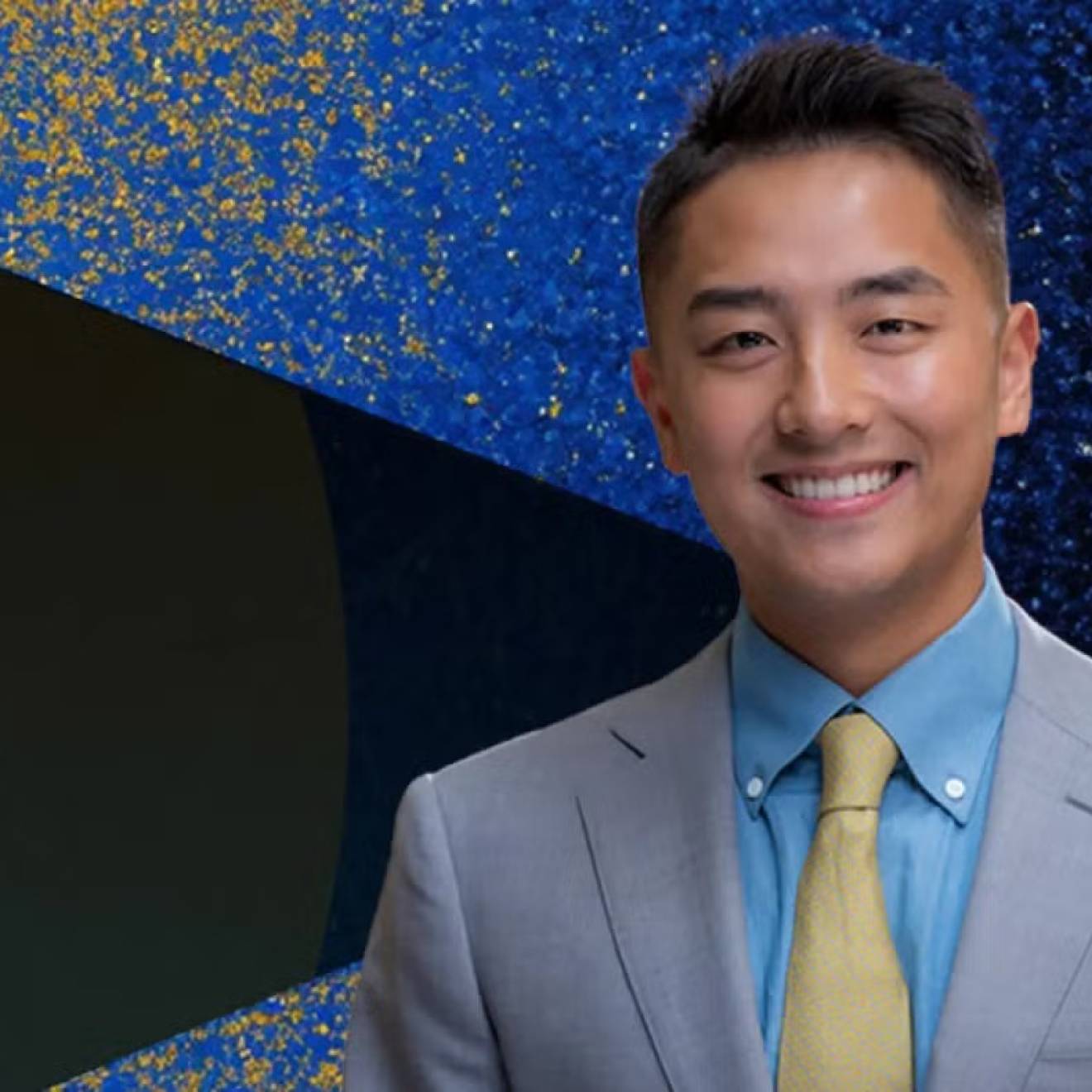 Young man in a suit smiling with John Wooden Leadership Fellows text on the left