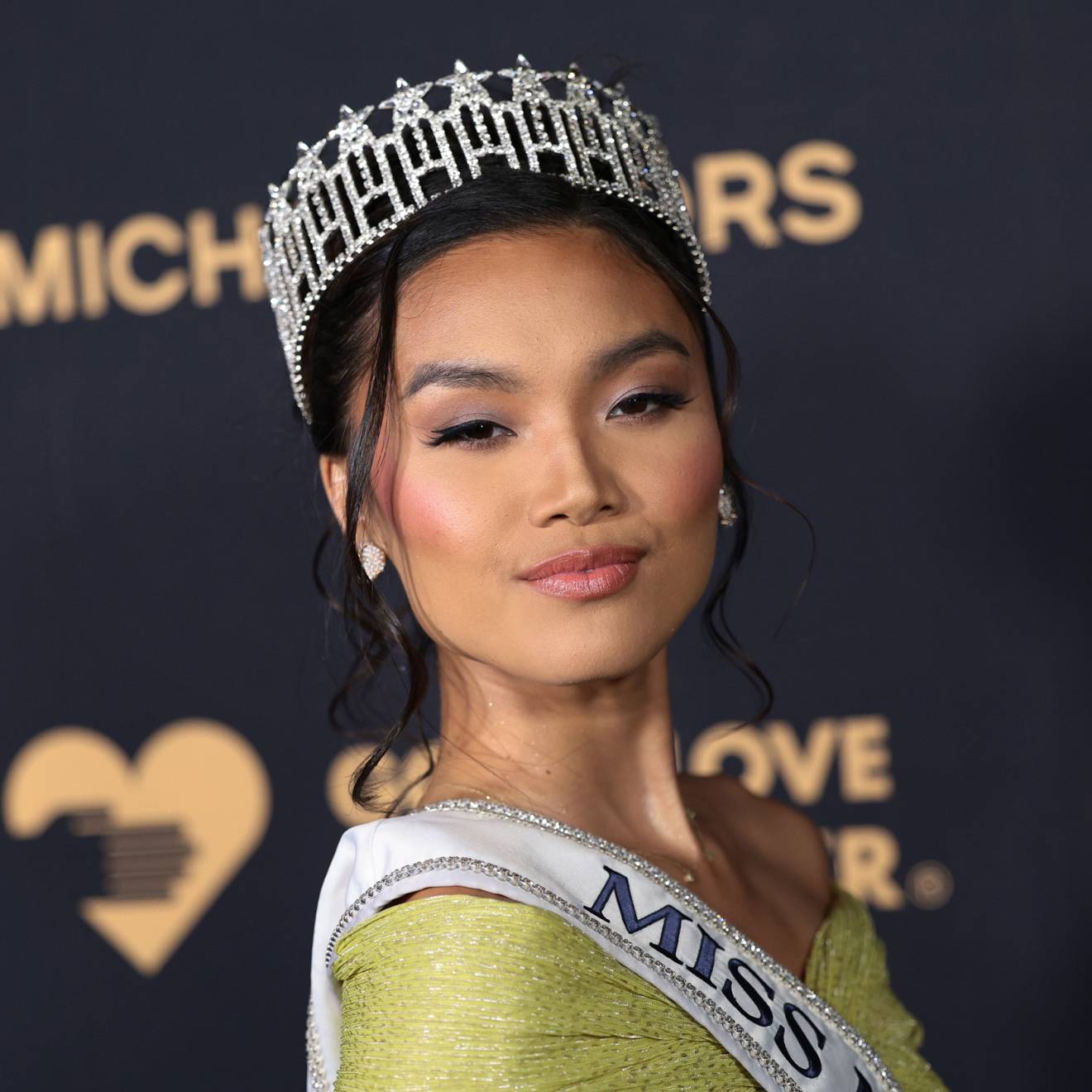 Young woman with a tiara, Marizza Delgado, poses at a Michael Kors event
