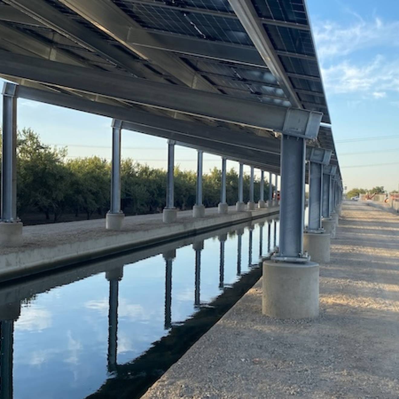 Solar panels over a canal near a highway