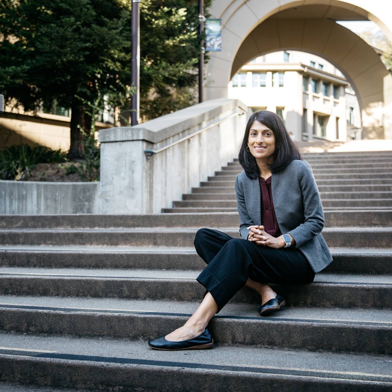 A professor sits on stairs on the UC Berkeley campus